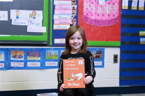 student holding book