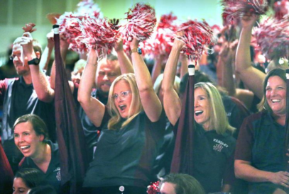  staff administrators cheering with pom poms