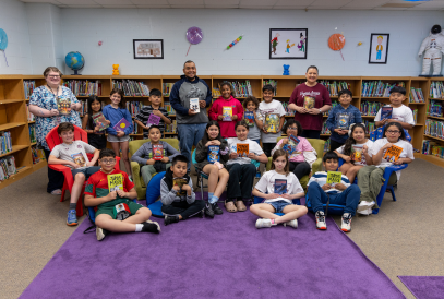  students in library holding books
